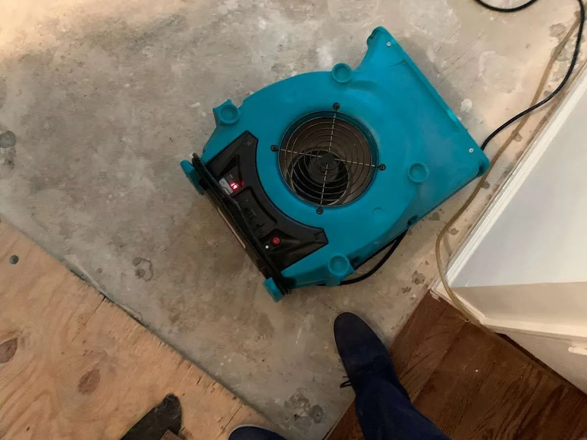 Air mover drying subfloor during Commercial Water Damage Restoration in Green Bay